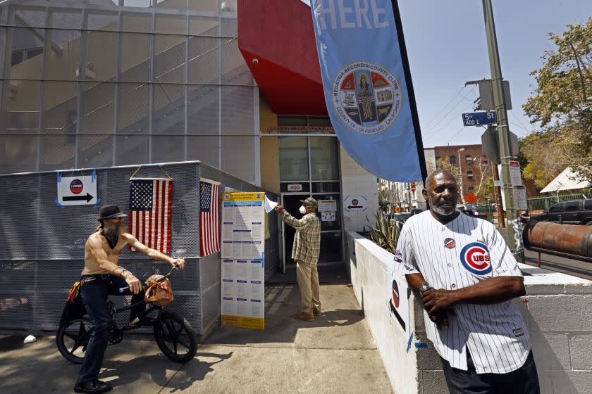 Los Angeles, California-June 7, 2022-Robert Hinkley, left, and Clyde Collins, right, who live in downtown Los Angeles stand outside the polling station at 400 E. 5th St., Los Angeles on June 7, 2022. Hinkley did not vote, but Collins did. (Carolyn Cole / Los Angeles Times)