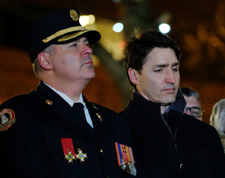 Canada's Prime Minister Justin Trudeau (R) stands with area residents as they gather for a vigil in support of a Syrian refugee family who lost seven children killed in a house fire in the community of Spryfield earlier in the week, in Halifax, Nova Scotia, Canada, February 20, 2019, REUTERS/Ted Pritchard