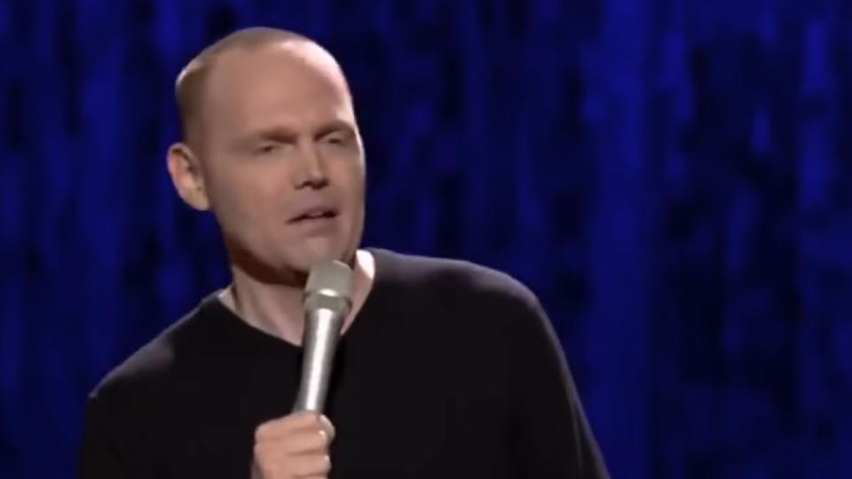 Bill Burr looking annoyed, with a microphone in his hand