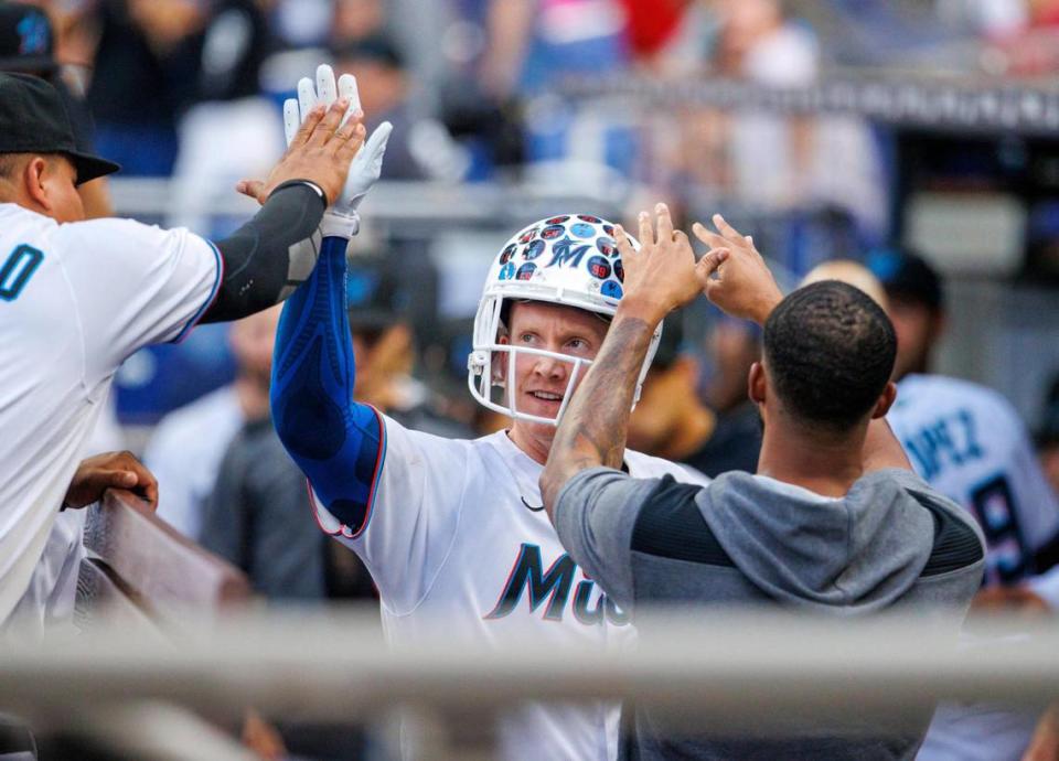 Miami Marlins designated hitter Garrett Cooper (26) celebrates with teammates after hitting a two run home run during the third inning of a baseball game against the Colorado Rockies at LoanDepot Park on Wednesday, June 22, 2022 in Miami, Florida.