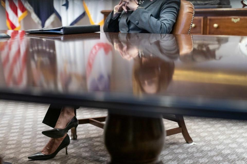 Vice President Kamala Harris sits at a table in the Roosevelt Room.