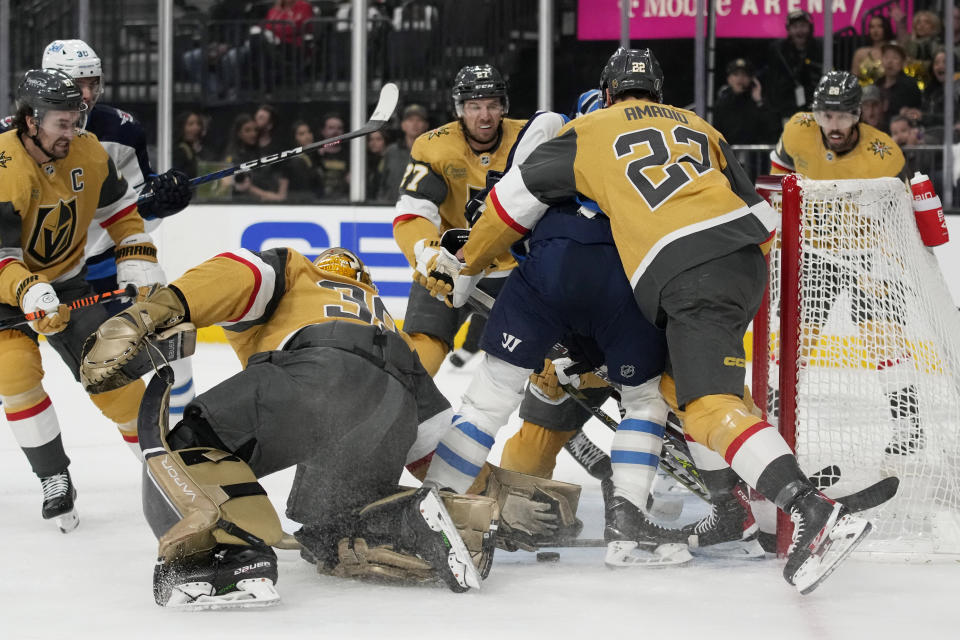 Vegas Golden Knights goaltender Laurent Brossoit (39) grabs the puck against the Winnipeg Jets during the first period of Game 1 of an NHL hockey Stanley Cup first-round playoff series Tuesday, April 18, 2023, in Las Vegas. (AP Photo/John Locher)