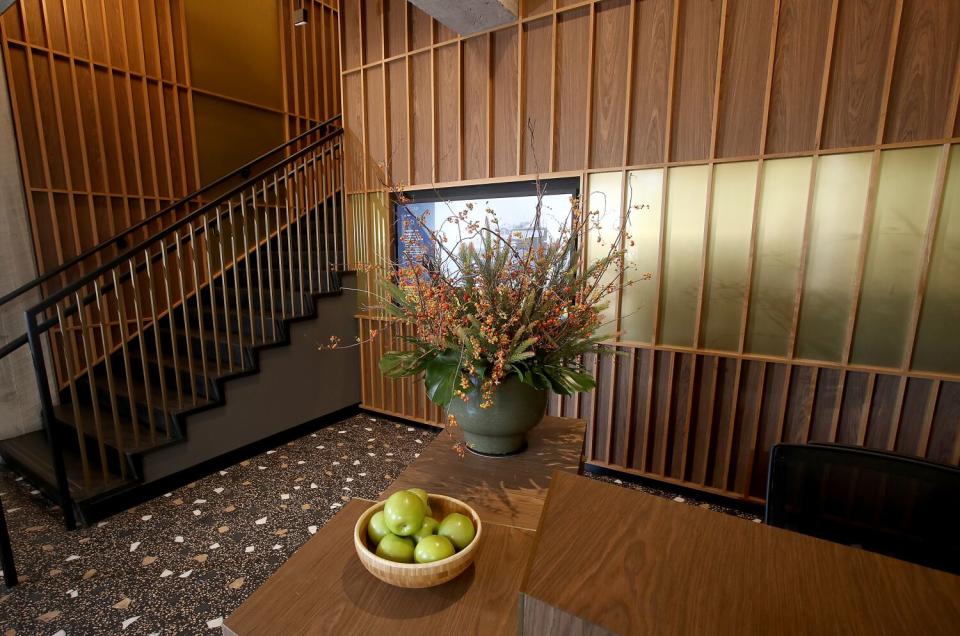 A wood-paneled room with stairs on the left.