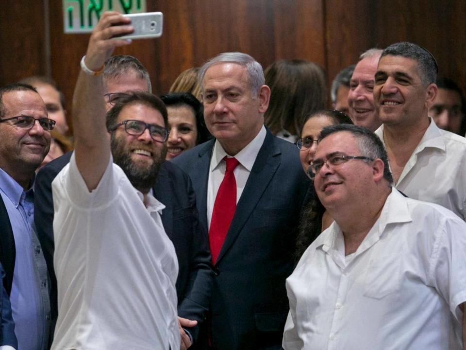 Knesset member Oren Hazan takes a selfie with Israel's Prime Minister Benjamin Netanyahu after the session (AP)