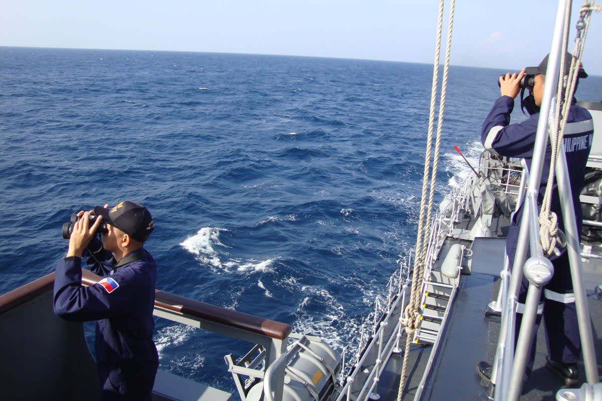 Searching: Philippine navy personnel scour the South China Sea for flight MH370 (AFP/Getty Images)