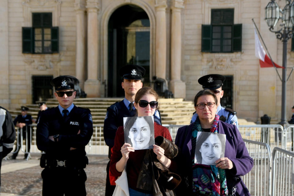 Daphne Caruana Galizia's Sister Mandy Mallia, right, protests outside the office of the Prime Minister at Castille, in Valletta, Malta, Tuesday, Dec. 3, 2019, as a delegation od European Union lawmakers is visiting the country after an investigation into the murder of leading investigative journalist Daphne Caruana Galizia implicated Prime Minister Joseph Muscat’s chief of staff. (AP Photo/Rene Rossignaud)