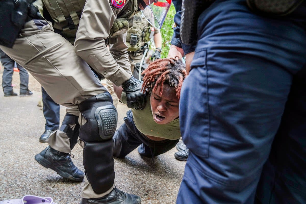 A demonstrator is restrained by police at a pro-Palestinian protest at the University of Texas (AP)