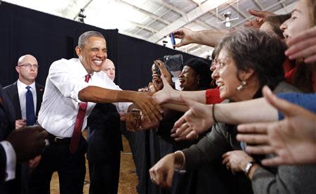 U.S. President Barack Obama shakes hands as he arrives to speak during a visit to North Carolina State University in Raleigh January 15, 2014. REUTERS/Kevin Lamarque