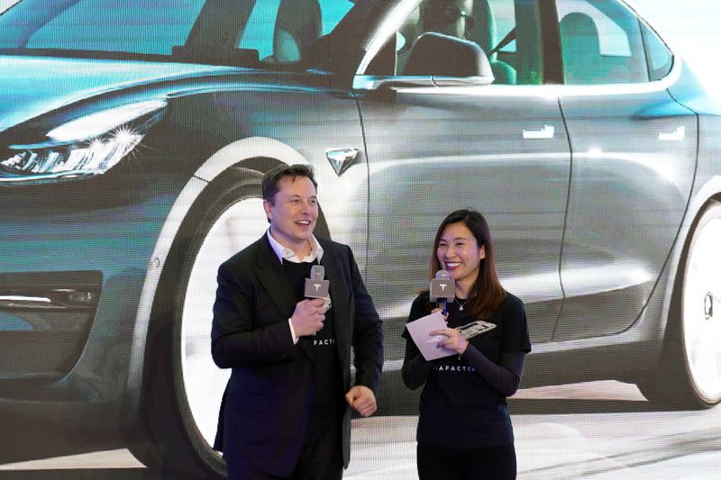 Tesla Inc's Elon Musk and Grace Tao attend a delivery ceremony for the EV maker's China-made Model 3 cars in Shanghai