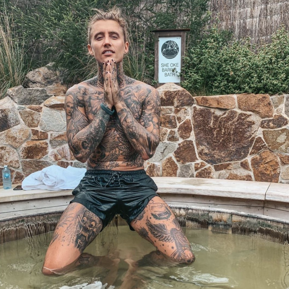 Bachelor In Paradise season three cast member Ciarran Stott wearing black shorts while sitting on the edge of a hot tub