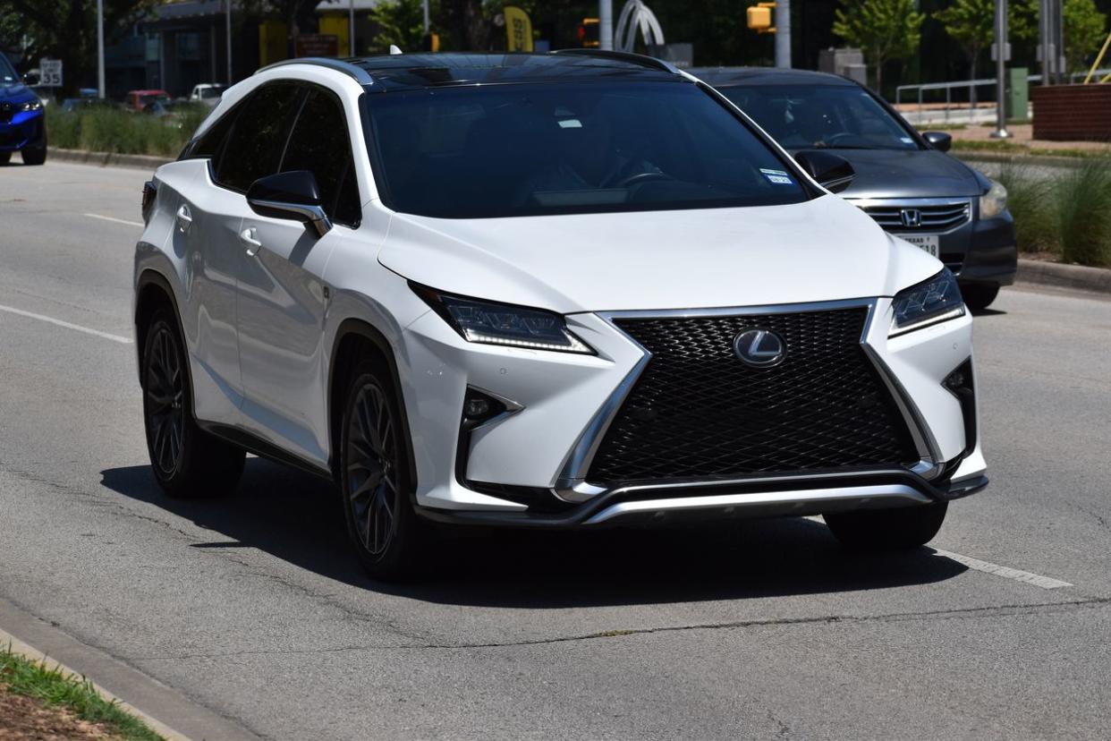 A white Lexus and Grey Honda