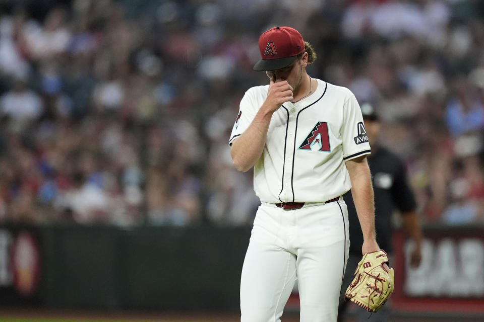 Arizona Diamondbacks starting pitcher Brandon Pfaadt walks off the field after giving up three runs to the St. Louis Cardinals during the first inning of a baseball game Friday, April 12, 2024, in Phoenix. (AP Photo/Ross D. Franklin)