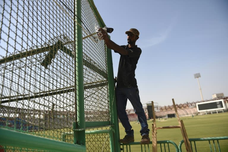 A Pakistani technician installs a security camera at Karachi's National Cricket Stadium