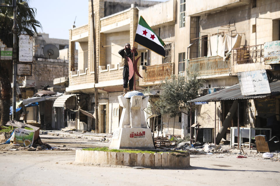 Turkish backed Syrian rebels enter the own of Saraqeb, in Idlib province, Syria, Thursday, Feb. 27, 2020. Turkey-backed Syrian opposition fighters Thursday retook a strategic northwestern town iof Saraqeb, opposition activists said, and cut off the key highway linking the capital, Damascus, with the northern city of Aleppo, days after the government reopened it for the first time since 2012. (AP Photo/Ghaith Alsayed)