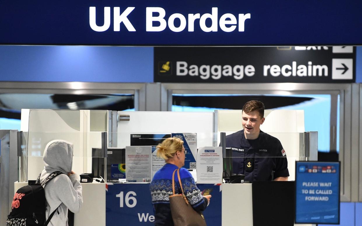 A member of the military at passport control at Manchester Airport on Thursday as the military covers for striking Border Force officers - PA