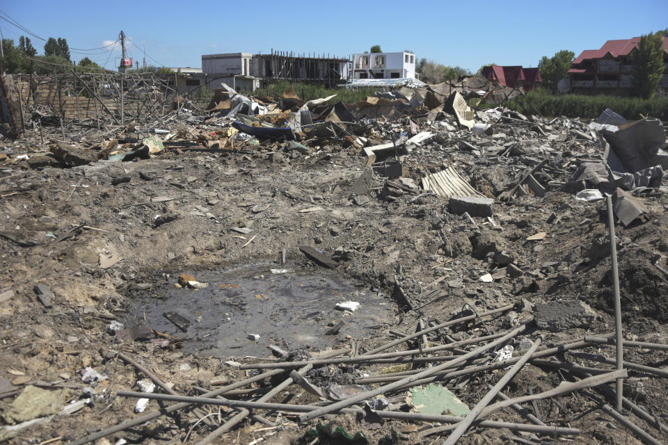 A crater of an explosion is seen in a residence area following Russian shelling on the outskirts of Odesa, Ukraine, Tuesday, July 26, 2022. (AP Photo/Michael Shtekel)