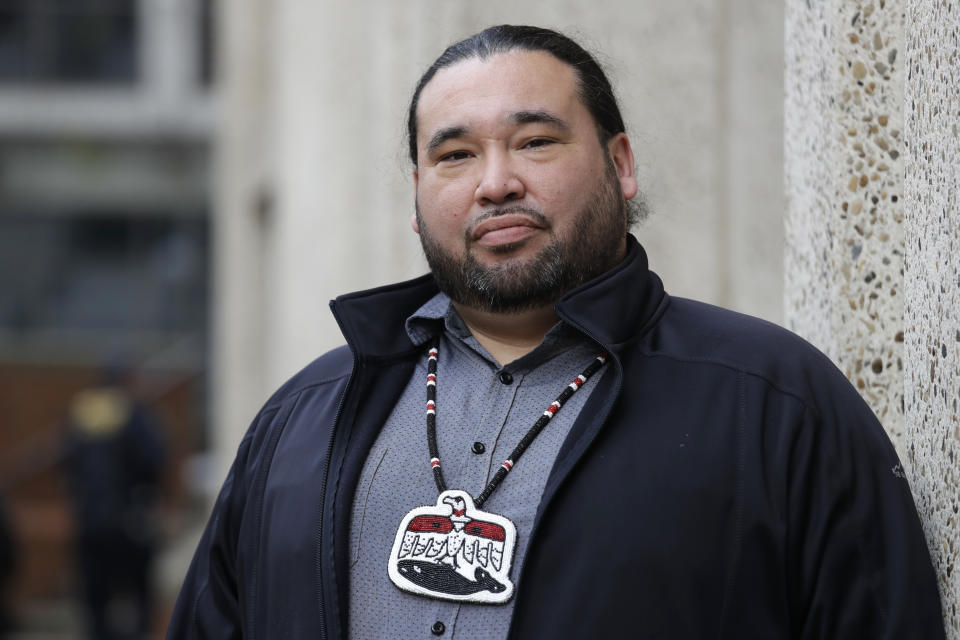 FILE - In this Nov. 14, 2019, file photo, Makah Tribe Vice Chairman Patrick DePoe poses for a photo before a federal hearing to help determine whether his small American Indian tribe from Washington state can once again hunt whales in Seattle. Nearly two years after the hearing, an administrative law judge on Thursday, Sept. 23, 2021, recommended that the Makah be allowed to resume whaling along the coast as their ancestors did. (AP Photo/Elaine Thompson, File)