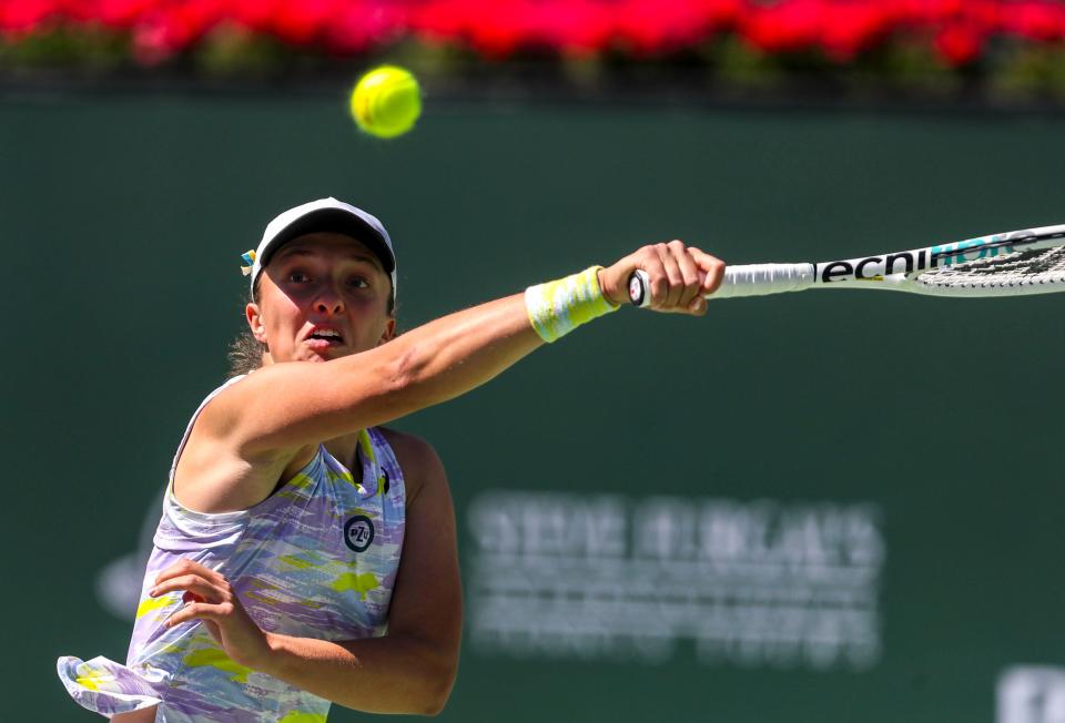 Iga Swiatek of Poland hits a shot to Maria Sakkari of Greece during the WTA singles final at the BNP Paribas Open at the Indian Wells Tennis Garden in Indian Wells, Calif., Sunday, March 20, 2022. 