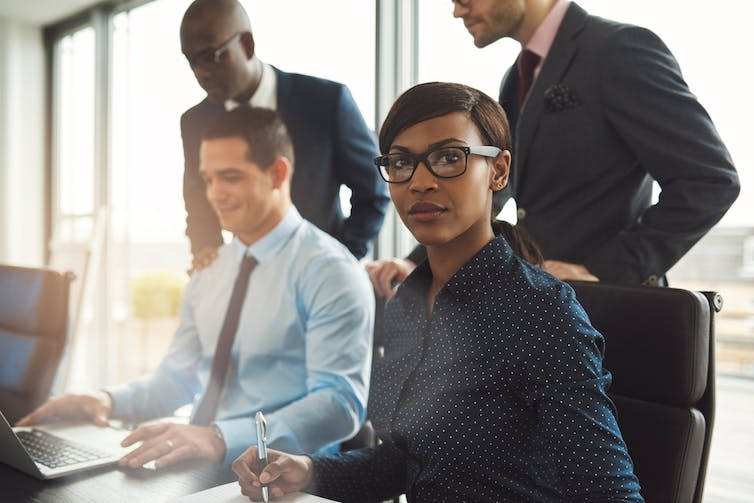 Four employees of different races gathered together