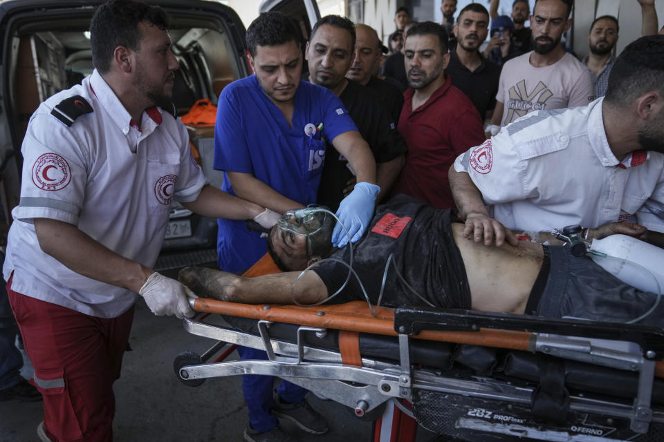 An injured Palestinian is carried into a hospital during an Israeli military raid in the Jenin refugee camp, a militant stronghold in the occupied West Bank, Monday, July 3, 2023. Israeli drones struck targets in the area early Monday and hundreds of troops were deployed. Palestinian health officials said at least eight Palestinians were killed. (AP Photo/Nasser Nasser)