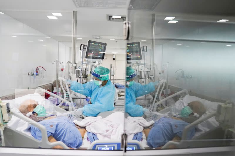 Medical workers take care of the coronavirus disease (COVID-19) patients in the ICU room in Bangkok