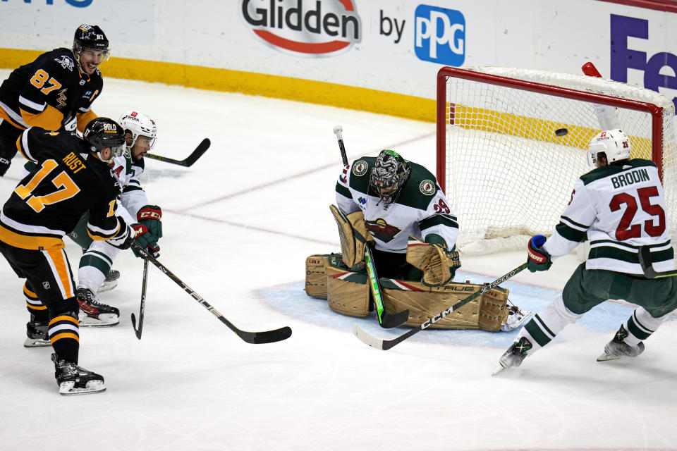 A shot by Pittsburgh Penguins' Bryan Rust (17) goes high over Minnesota Wild goaltender Marc-Andre Fleury (29), missing the net, during the first period of an NHL hockey game in Pittsburgh, Thursday, April 6, 2023. (AP Photo/Gene J. Puskar)