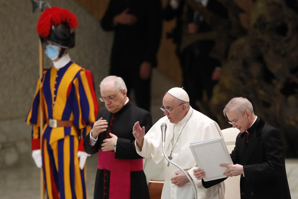 Pope Francis delivers his blessing in the Paul VI Hall at the Vatican at the end of his weekly general audience, Wednesday, Oct. 28, 2020. A Vatican official who is a key member of Francis' COVID-19 response commission, the Rev. Augusto Zampini, acknowledged Tuesday that at age 83 and with part of his lung removed after an illness in his youth, Francis would be at high risk for complications if he were to become infected. Zampini said he hoped Francis would don a mask at least when he greeted people during the general audience. "We are working on that," he said. (AP Photo/Alessandra Tarantino)