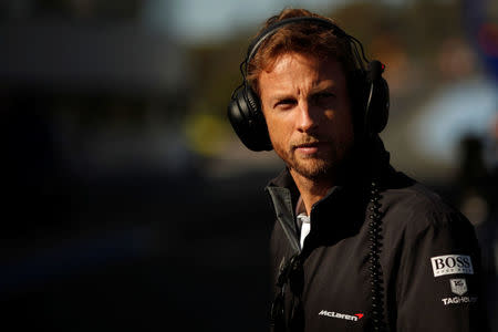 FILE PHOTO - McLaren Formula One driver Jenson Button of Britain stands in the pit lane during pre-season testing at the Jerez racetrack in southern Spain January 30, 2014. REUTERS/Jon Nazca/File Photo