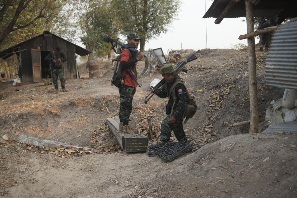 Members of the Karen National Liberation Army and People’s Defense Force collect weapons after they captured an army outpost, in the southern part of Myawaddy township in Kayin state, Myanmar, March 11, 2024. (AP Photo/METRO)