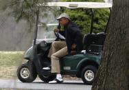 U.S. President Barack Obama rides a golf cart at Joint Base Andrews outside Washington, March 22, 2014. REUTERS/Yuri Gripas (UNITED STATES - Tags: POLITICS)