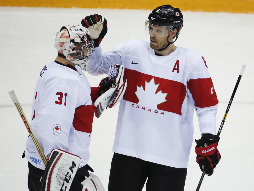 Canada defenseman Shea Weber congratulates Canada goaltender Carey Price after Canada defeated Latvia 2-1in a men's quarterfinal ice hockey game at the 2014 Winter Olympics, Wednesday, Feb. 19, 2014, in Sochi, Russia. (AP Photo/Mark Humphrey)