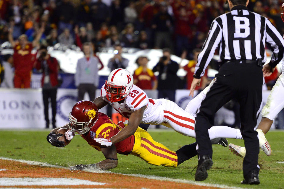 Dec 27, 2014; San Diego, CA, USA; USC Trojans running back Javorius Allen (37) dives into the endzone as Nebraska Cornhuskers defensive back Byerson Cockrell (28) defends during the third quarter in the 2014 Holiday Bowl at Qualcomm Stadium. Mandatory Credit: Jake Roth-USA TODAY Sports