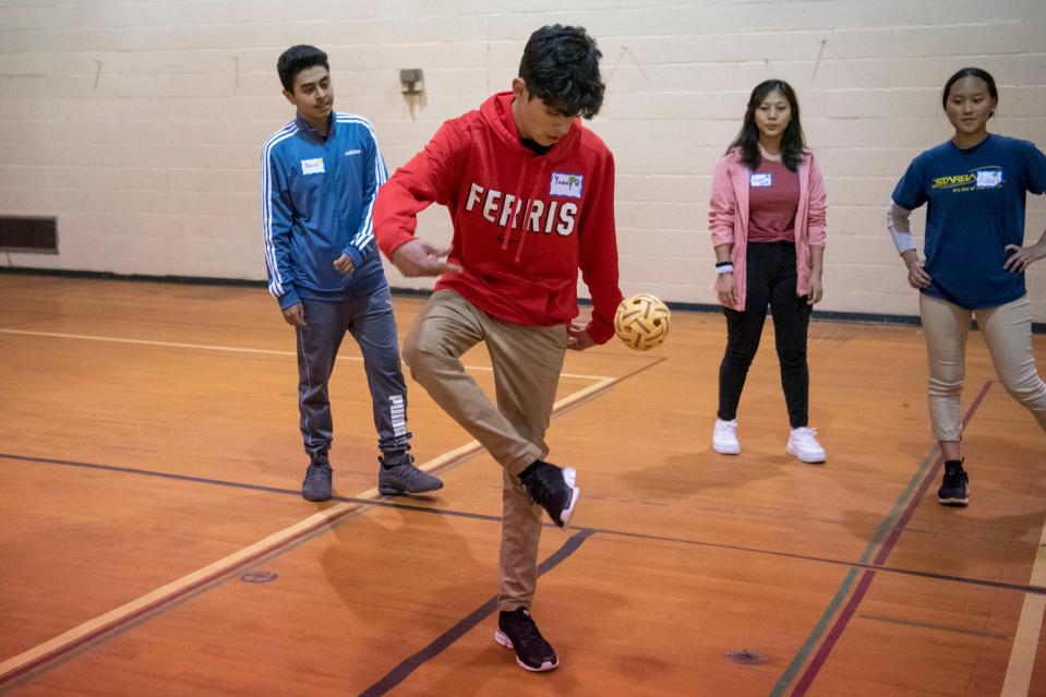 Lakeview freshman Yanaq Quispe kicks the takraw ball during a game of chinlone at the Burma Center in Springfield, Michigan on Wednesday, April 27, 2022.