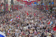 People carry portraits of relatives who fought in World War II, during the Immortal Regiment march at the Nevsky prospect, the central avenue of St. Petersburg, Russia, Monday, May 9, 2022, on the occasion of the 77th anniversary of the end of World War II. (AP Photo/Dmitri Lovetsky)