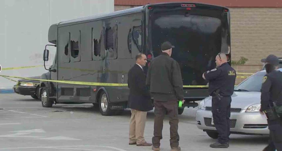 Police at a crime scene after 70 rounds were fired at a party bus in the San Francisco Bay Area.