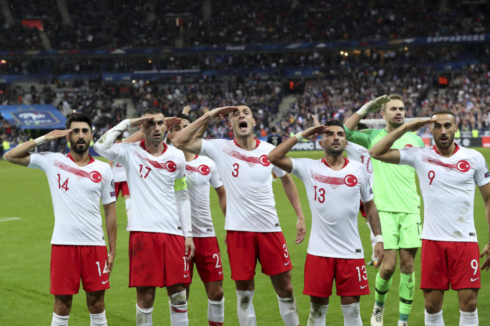 FILE-In this Monday, Oct. 14, 2019 file photo, Turkey's players salute as they celebrate a goal against France during the Euro 2020 group H qualifying soccer match between France and Turkey at Stade de France at Saint Denis, north of Paris, France. Since Turkey announced its incursion into neighbouring Syria to clear out Kurdish fighters last week, patriotic sentiment has run high, with the National soccer team players giving military salutes during international matches among the outward signs of nationalism. (AP Photo/Thibault Camus, File)