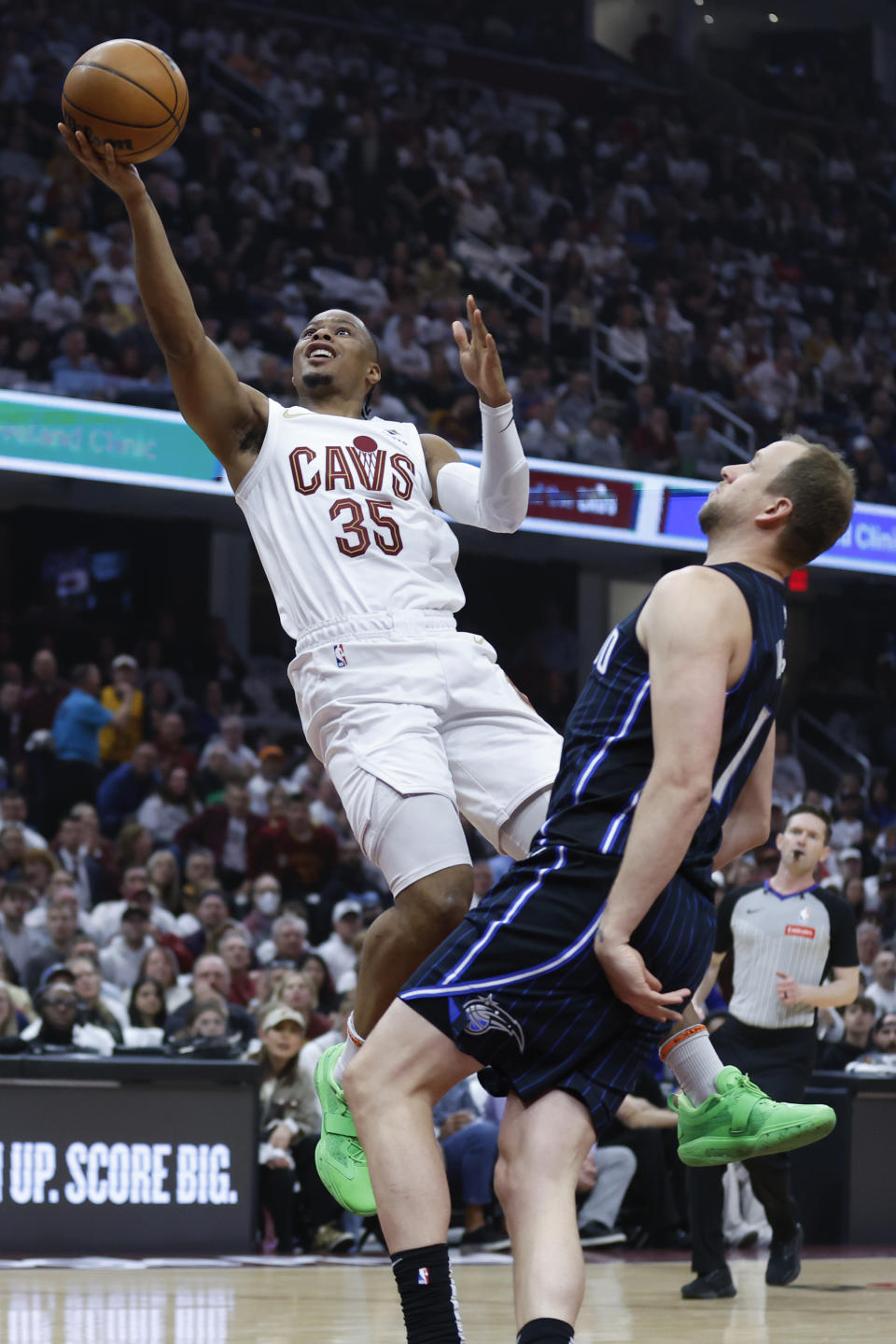 Cleveland Cavaliers forward Isaac Okoro (35) shoots against Orlando Magic guard Joe Ingles, right, during the first half of Game 2 of an NBA basketball first-round playoff series, Monday, April 22, 2024, in Cleveland. (AP Photo/Ron Schwane)