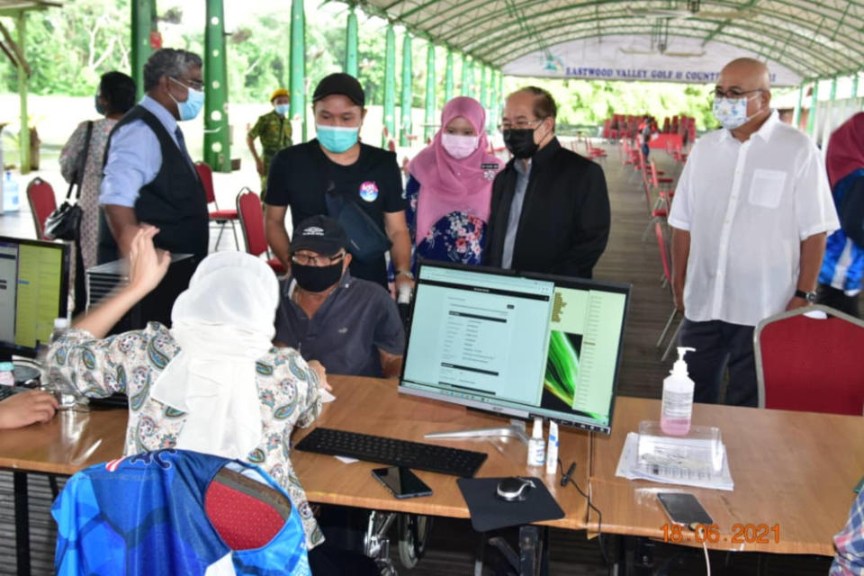 Deputy Chief Minister Datuk Amar Douglas Uggah observing the registration process for Covid-19 vaccination at the vaccine administration centre at Eastwood Valley Golf and Country Club in Miri, June 18, 2021. — Picture courtesy of the Deputy Minister’s Office