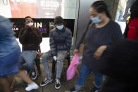 FILE - Shoppers wear face masks on a crowded sidewalk in Pretoria, South Africa, Saturday, Nov. 27, 2021. The world is racing to contain a new COVID-19 variant, which appears to be driving a surge in South Africa and is casting a pall there. (AP Photo/Denis Farrell, File)