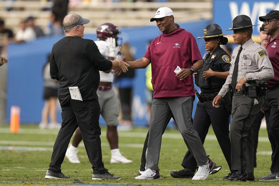 UCLA head coach Chip Kelly, left, and North Carolina Central head coach Trei Oliver shake hands after UCLA defeated North Carolina Central 59-7 in an NCAA college football game Saturday, Sept. 16, 2023, in Pasadena, Calif. (AP Photo/Mark J. Terrill)