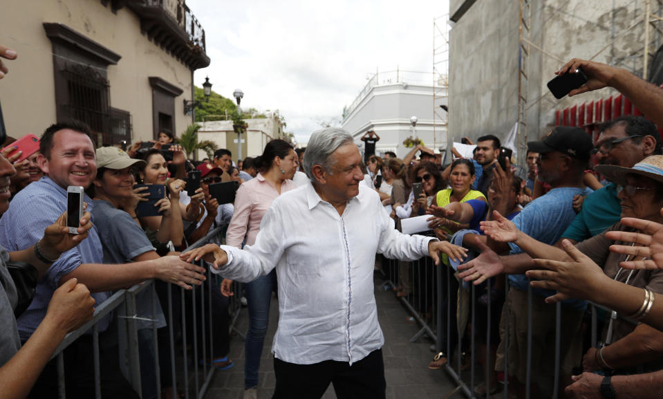 FILE - In this Sept. 16, 2018 file photo, Mexico's President-elect Andres Manuel Lopez Obrador greets supporters as he kicks off a nationwide tour after his election in Mazatlan, Mexico. Lopez Obrador is folksy, plain-spoken, and spontaneous, perhaps too much so for financial markets, which have been roiled in advance of his inauguration on Saturday. (AP Photo/Eduardo Verdugo, File)