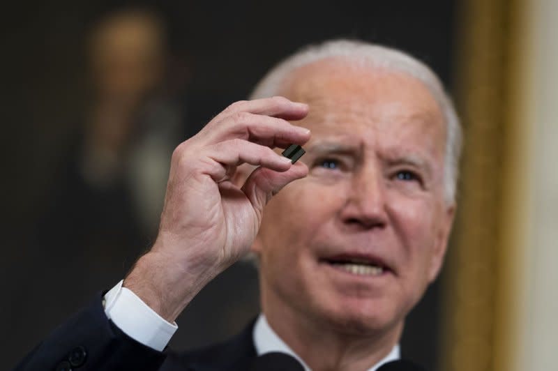 President Joe Biden on Tuesday increased tariffs on $18 billion of Chinese imports including semiconductors, like the one he is seen holding here in a speech at the White House on February 24, 2021. File Pool Photo by Doug Mills/UPI
