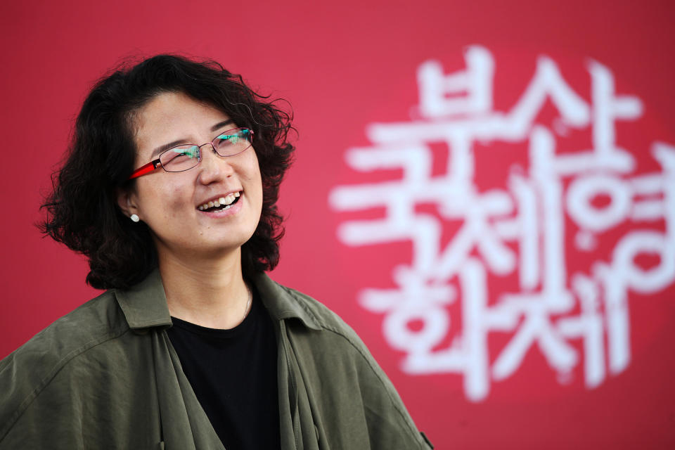 In this Oct. 4, 2013 photo, South Korean Director Kim Lyang poses during an interview with the Associated Press at Busan Cinema Center in Busan, South Korea. Kim, a South Korean based in France, said her first documentary feature was a chance for her to tell stories as a second generation of a divided family. Her father was born in North Korea, and she grew up without knowing any extended family on his side. (AP Photo/Woohae Cho)