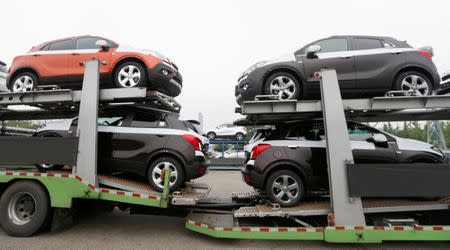 Cars made by GM Korea are seen on trucks in a yard of GM Korea's Bupyeong plant before they are transported to a port for export, in Incheon, west of Seoul August 9, 2013. REUTERS/Lee Jae-Won/Files