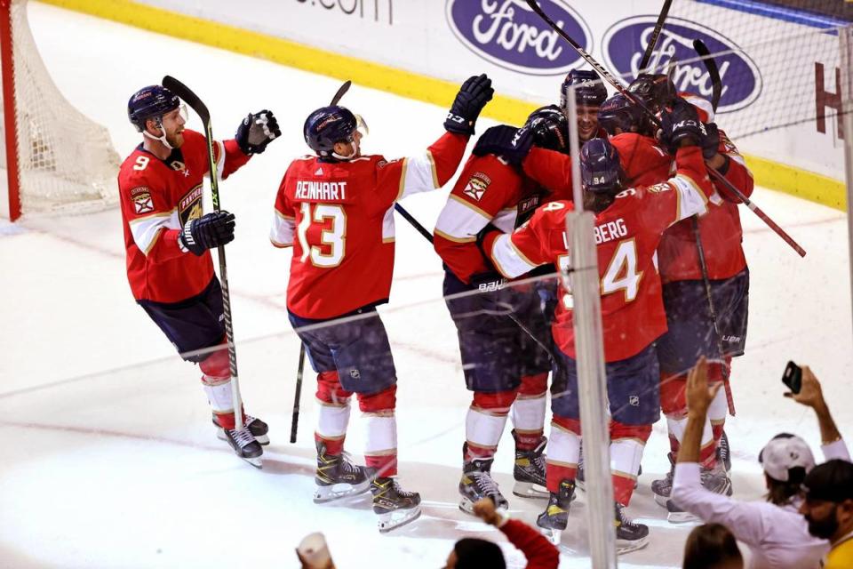 Florida Panthers left wing Carter Verhaeghe (23) is congratulated by teammates after scoring the winning goal against Pittsburgh Penguins goaltender Casey DeSmith (1) during the overtime of the Florida Panthers NHL home opener game at the FLA Live Arena on Thursday, October 14, 2021 in Sunrise, Fl.