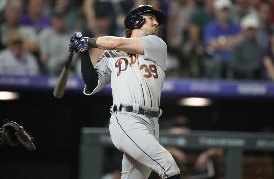 Detroit Tigers' Zach McKinstry follows through on a three-run home run off Colorado Rockies relief pitcher Pierce Johnson during the 10th inning of a baseball game Saturday, July 1, 2023, in Denver. (AP Photo/David Zalubowski)