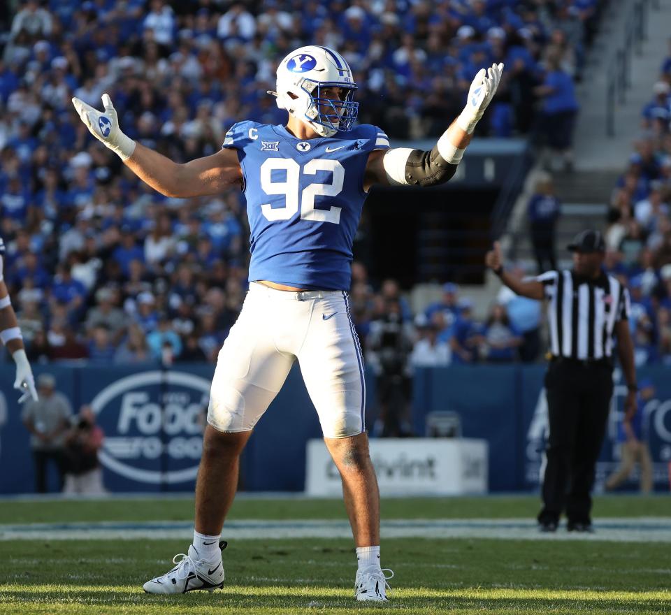 Brigham Young Cougars defensive end Tyler Batty (92) gestures to the fans to cheer louder against the Texas Tech Red Raiders in Provo on Saturday, Oct. 21, 2023. BYU won 27-14.