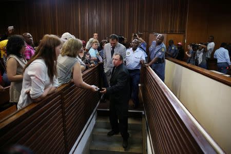 Farmers Willem Oosthuizen and Theo Martins are led down to holding cells after being sentenced for kidnap, assault and attempted murder, in connection with forcing a man into a coffin, in Middelburg, South Africa, October 27, 2017. REUTERS/Siphiwe Sibeko