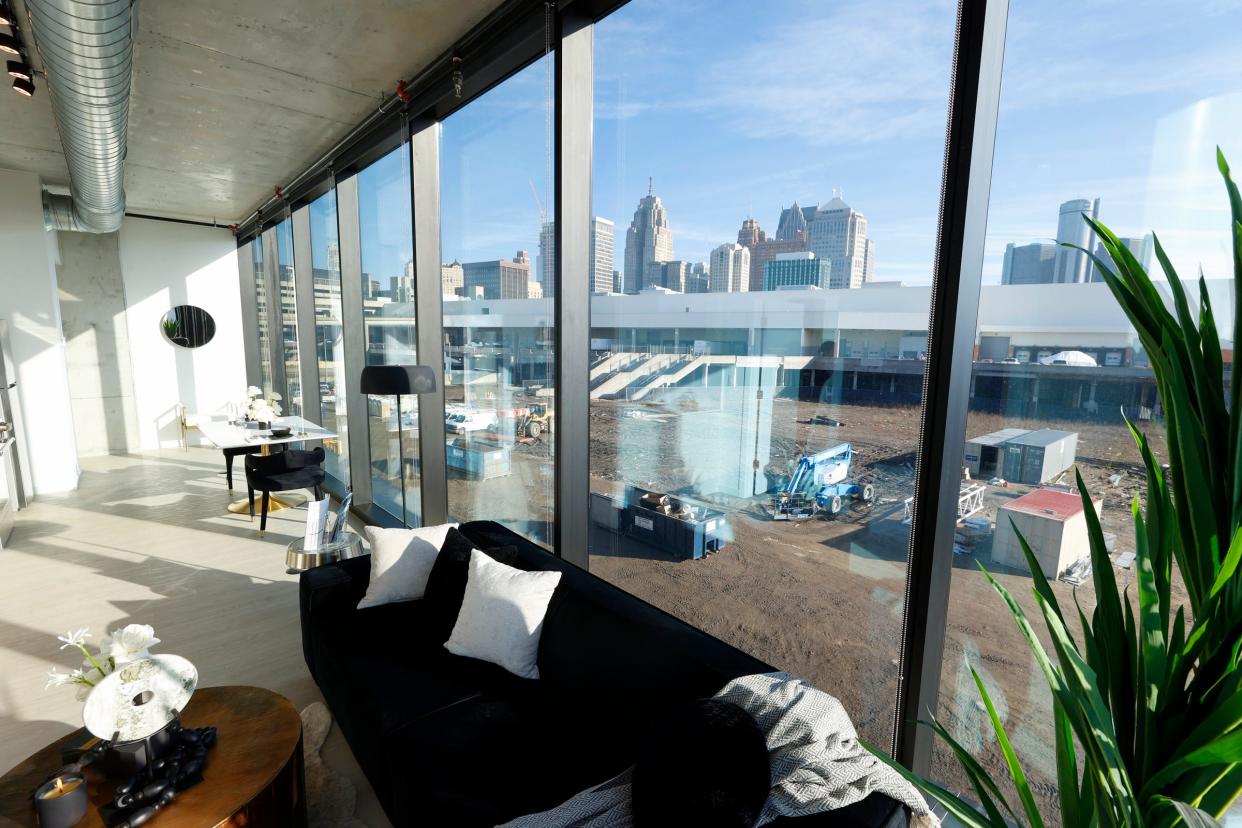 The living room and dining area inside a one-bedroom corner apartment at The Residences at Water Square, a new luxury apartment tower at the site of the former Joe Louis Arena in Detroit on Tuesday, Feb. 6, 2024.