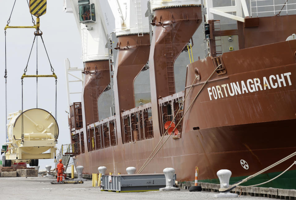 In this Monday, April 21, 2014 photo, the Amsterdam-bound Fortunagracht is loaded with road equipment to build highways, at the Port of Cleveland in Cleveland. The Commerce Department releases first-quarter gross domestic product on Wednesday, April 30, 2014. (AP Photo/Tony Dejak)